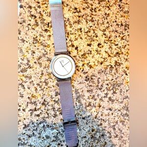 PX analog watch with a Milanese (mesh) strap